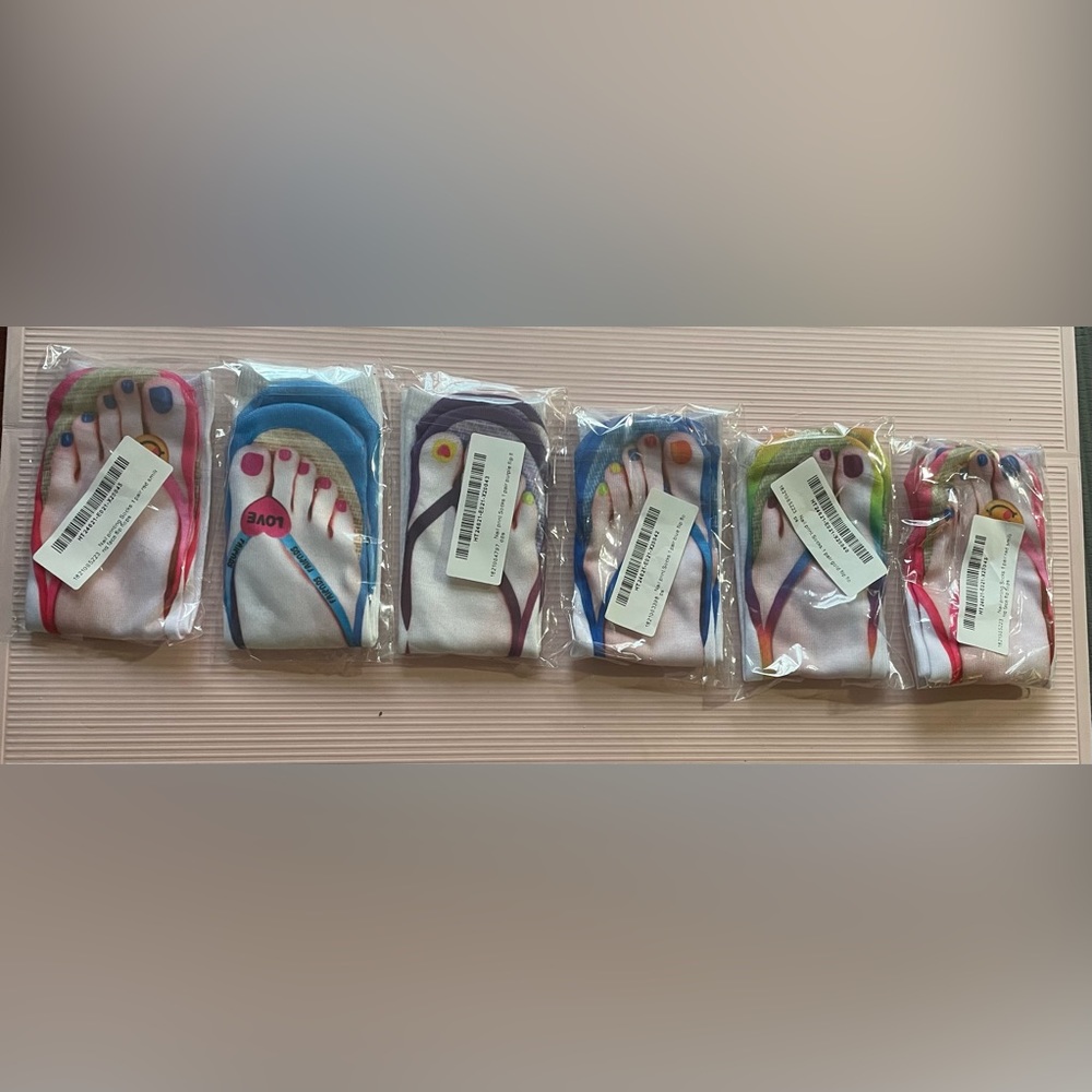 Nwts. 6 pairs sealed. 3 D printed socks-one size fits most. Nail polish pedicure